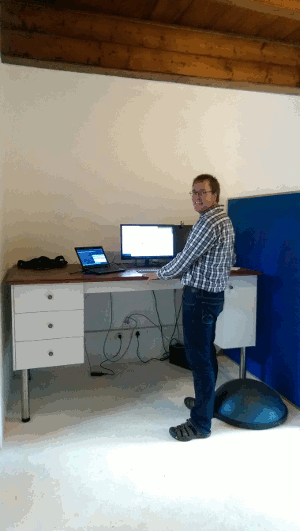 Richard working in Kartoza offices behind 'standing desk'